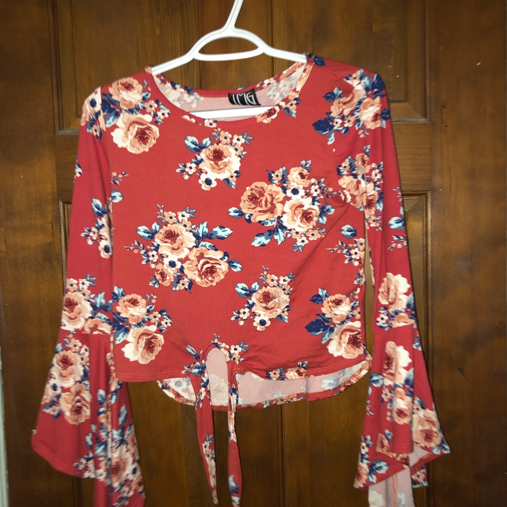 Floral top with tie front and bell sleeves.